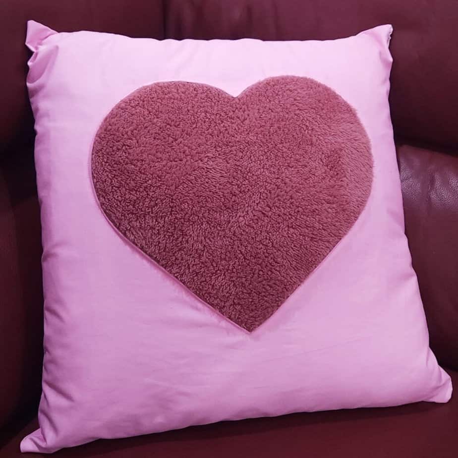 Square pink cushion with fluffy reverse applique heart