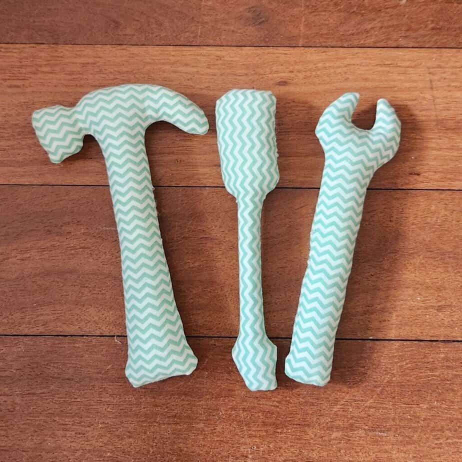 Plush baby tool set on a wooden floor