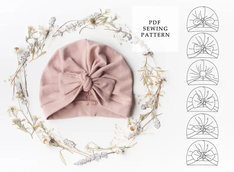 Soft pink baby headwrap with bow, suitable for newborn photography and special occasions.