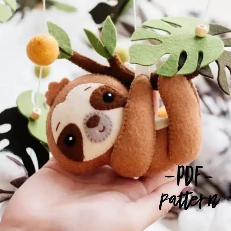 Soft felt sloth hanging from felt leaves craft owl plush toy, perfect for DIY plushie sewing projects.