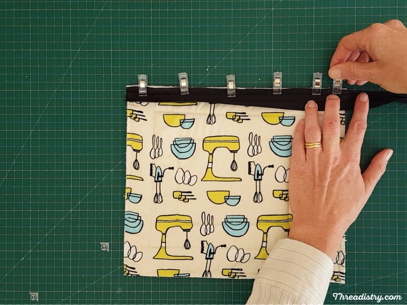 Attaching binding to one side of a pot holder