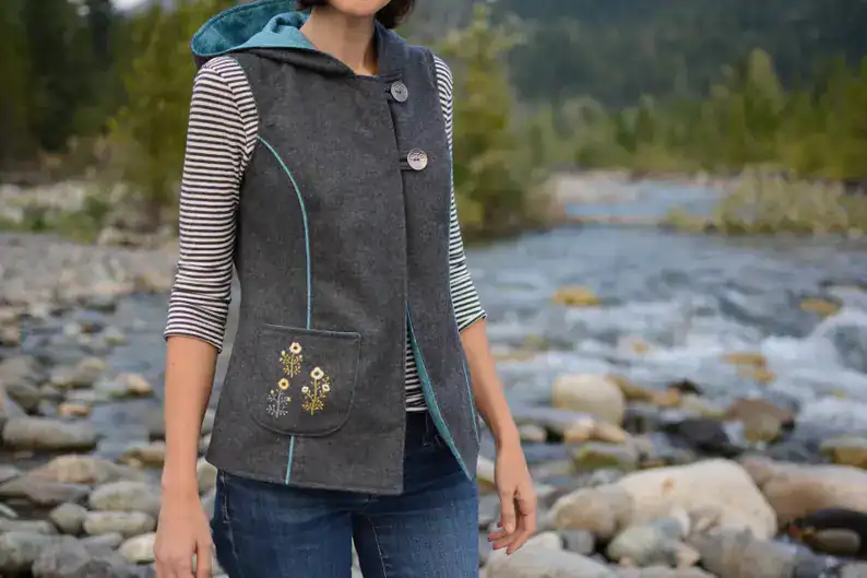 Colorful handmade felted vest with floral pocket detail, perfect for outdoor adventures and eco-friendly fashion.