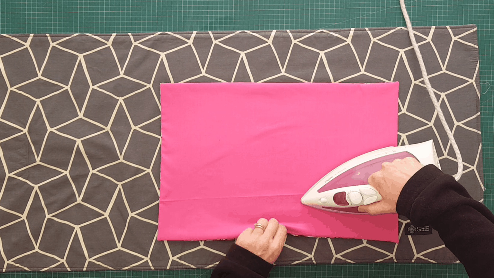 Overhead shot of a placemat being ironed.