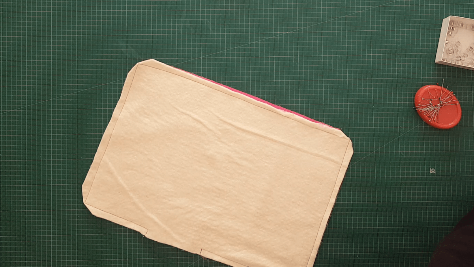 Rectangle of fabric sewn together and with corners of the fabric clipped.