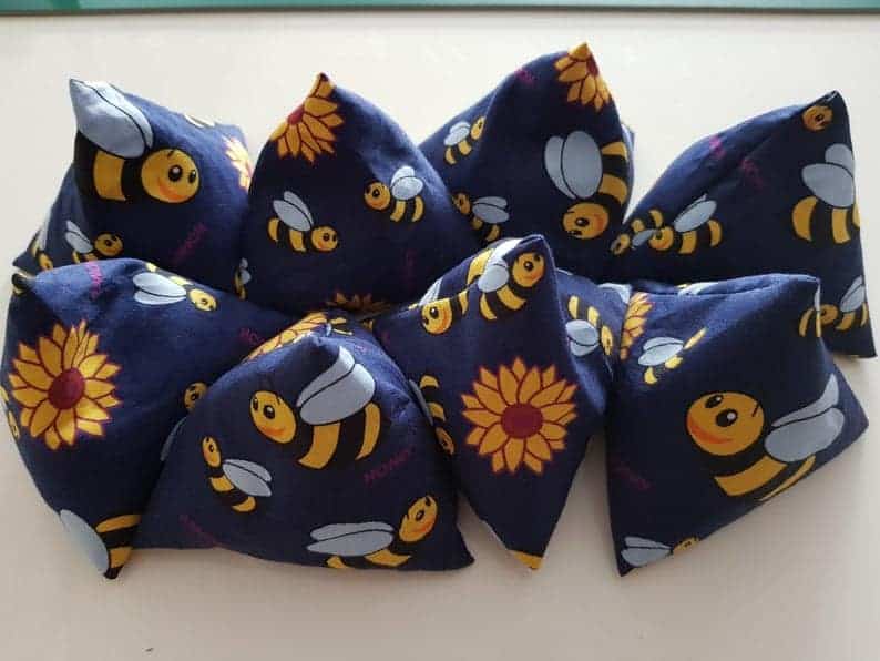 Pyramid sewing pattern weights made in blue fabric with bees and sunflowers