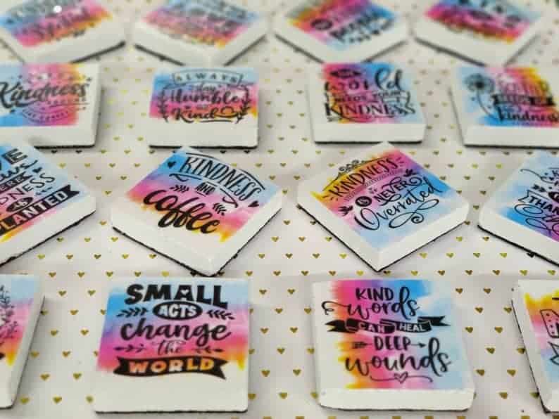 Square tile sewing pattern weights with kindness themed slogans