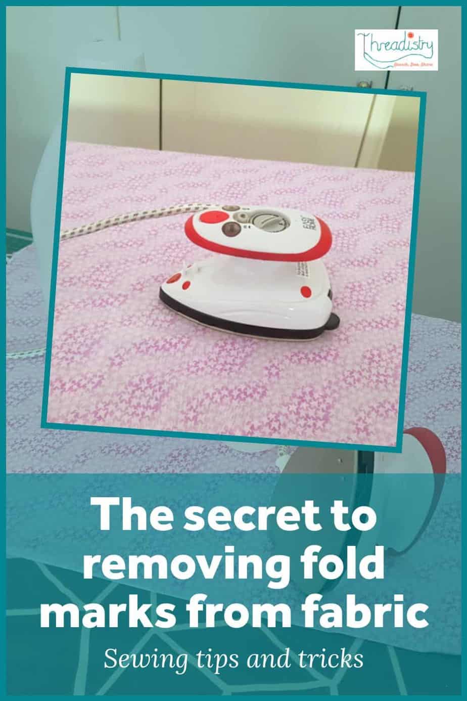 A small iron resting on fabric with text overlay "The Secret to removing fold marks from fabric"