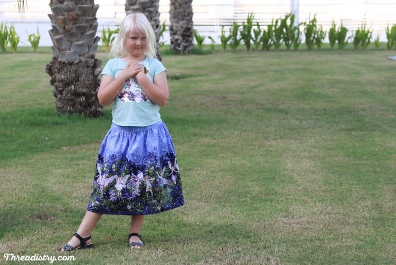 The Schatje Skirt sewing pattern from the Eli Monster has a flat front and elastic waist. It looks amazing in a border print.