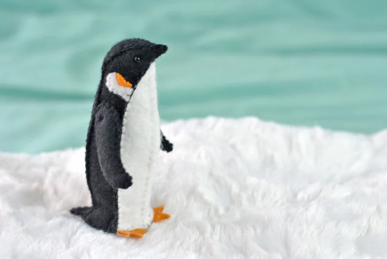 Realistic little penguin made from felt with jointed flippers