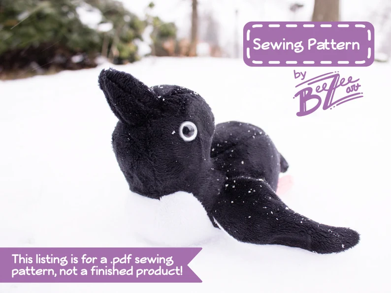 Plush penguin sliding on it's belly with text overlay "Sewing pattern bgy BeeZee Art"