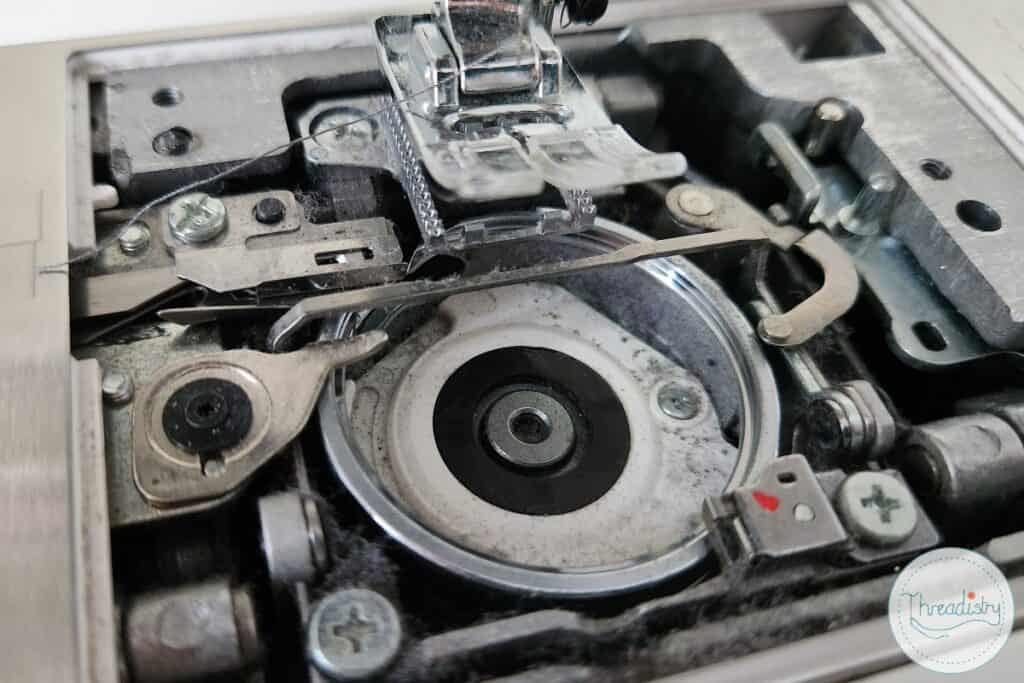 Lint and fluff inside bobbin area of sewing machine
