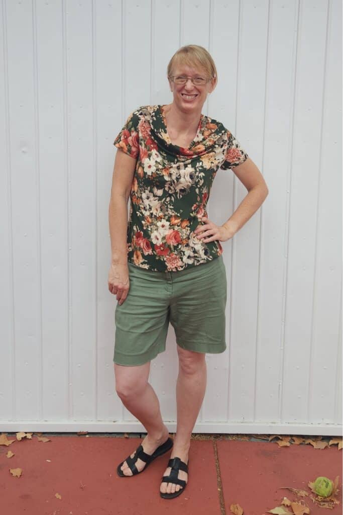 Narelle from Threadistry wearing a cowl neck top in a floral print with olive background.