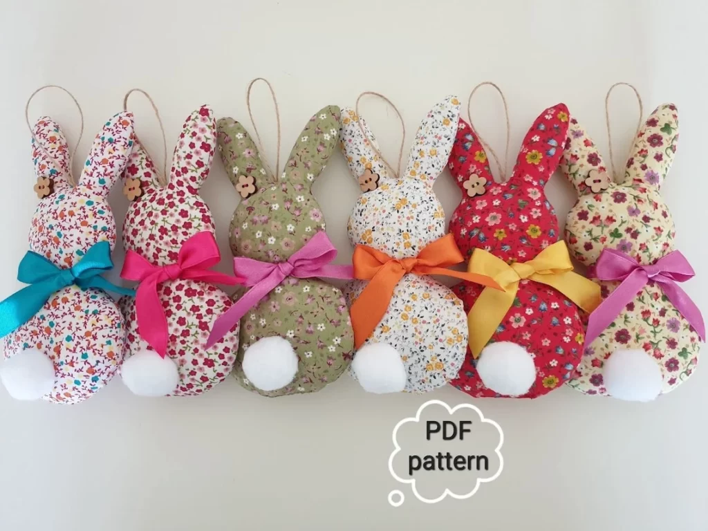 Row of Peeprs-style bunny ornaments made from small-print floral fabric and with white tails.