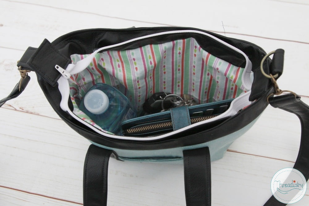 View inside Lily handbag showing small water bottle, phone and keys inside