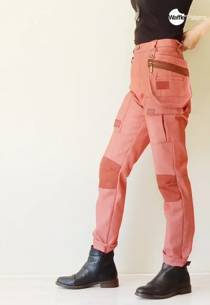 Stylish pink cargo pants with zipper pockets and reinforced knees for fashion and durability.