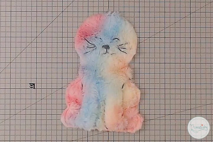 Soft pastel-colored plush kitten toy, cozy and adorable, perfect for kids and collectors.