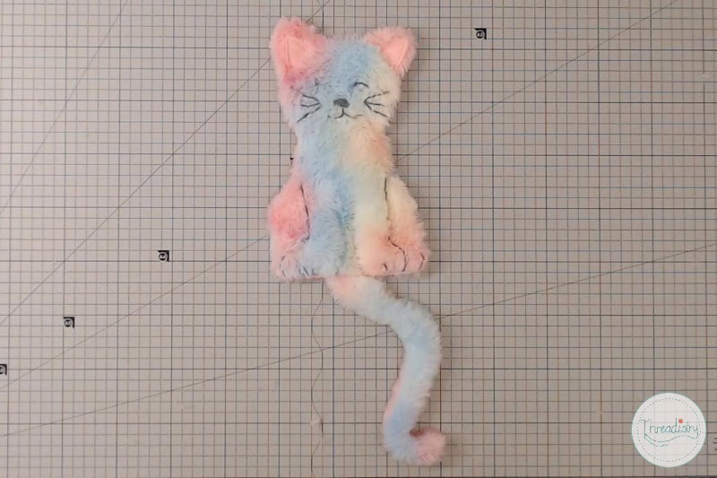 Soft pastel-colored plush cat toy with a fluffy tail, perfect for handmade gift or cat accessory.