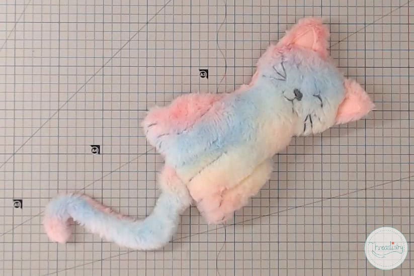 Soft pastel-colored plush cat toy for creative DIY sewing projects.