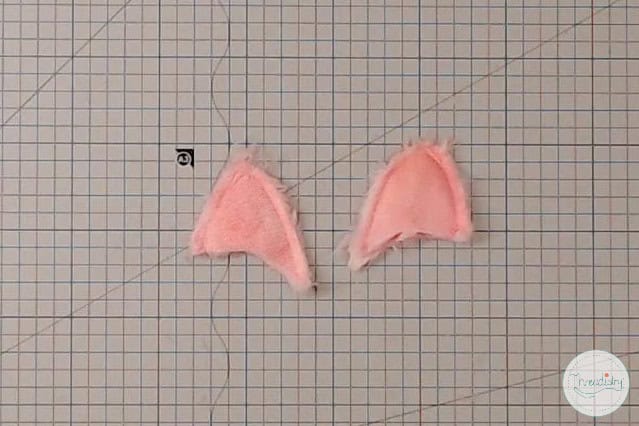 Pink fabric bunny ears for craft projects and costume accessories.