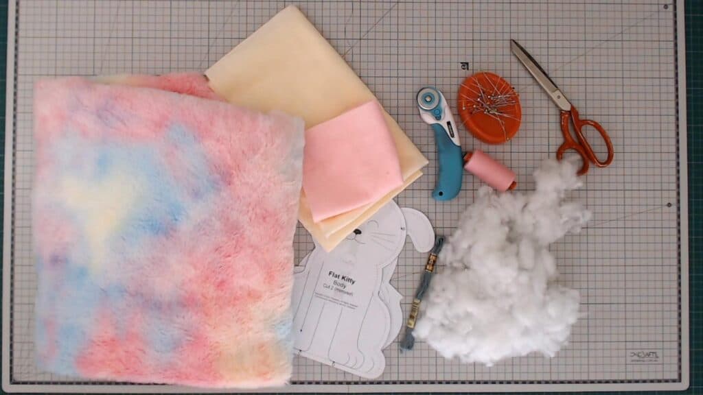 Colorful plush fabric and sewing supplies for custom toy making.