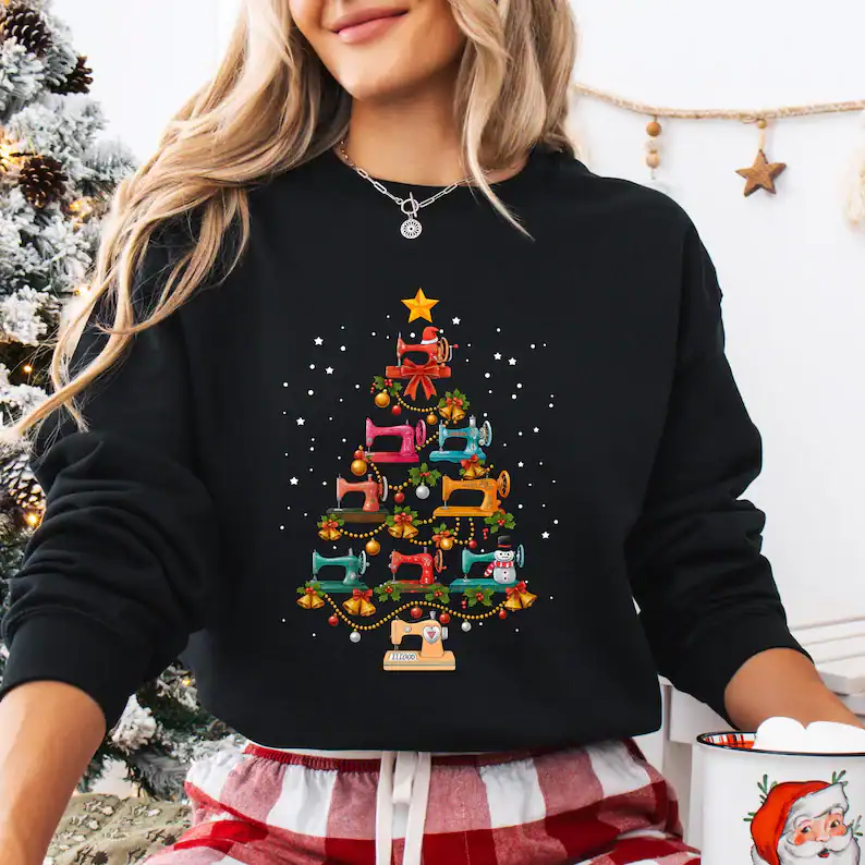 Cute Christmas sweater with colorful sewing machine design and holiday ornaments, perfect for festive winter fashion.