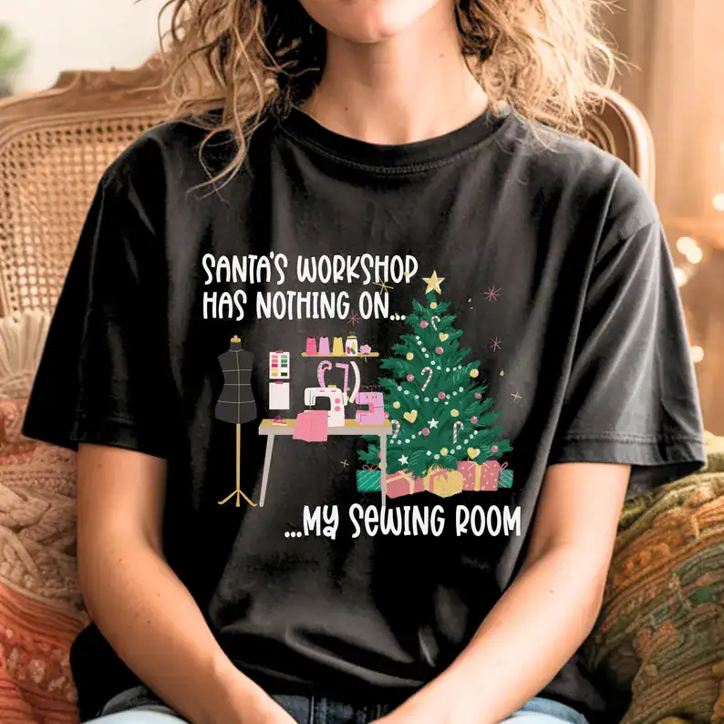 Santa's workshop humor t-shirt with sewing machine and Christmas tree, perfect for sewing enthusiasts during holidays.