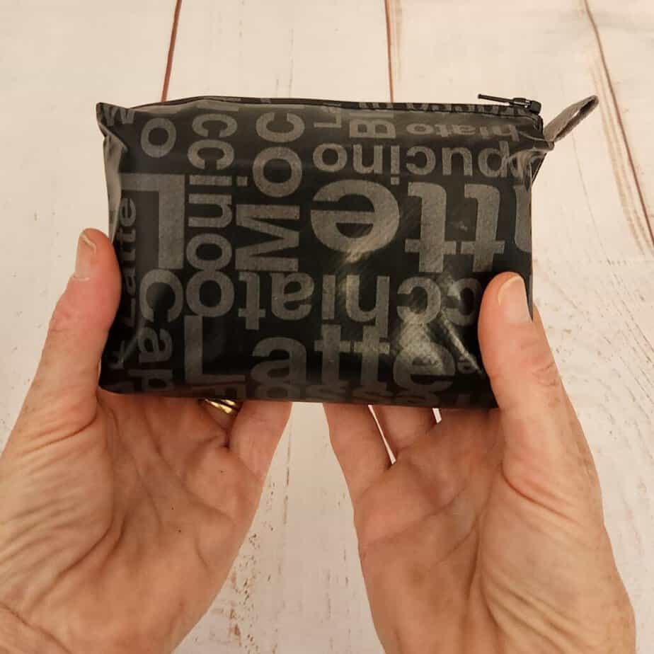 Colorful fabric pouch with bold text print, stylish and practical accessory for daily use.