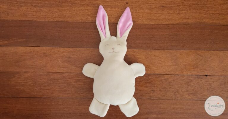 Handmade bunny plush toy with pink ears, perfect for sewing projects and kids' crafts.