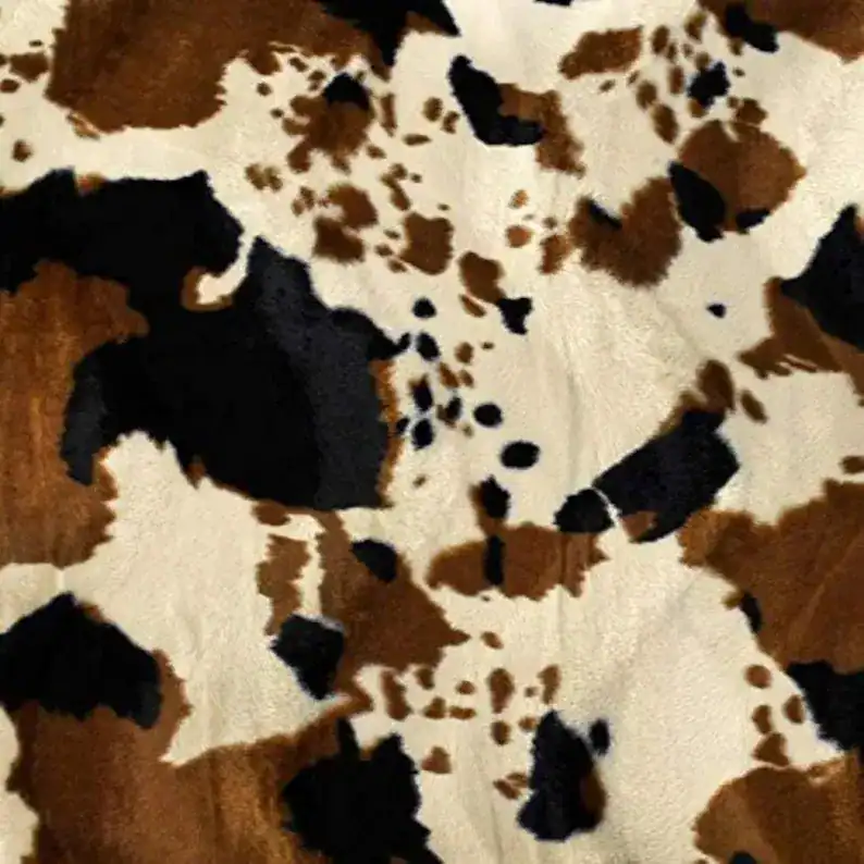 Cow print plush fabric ideal for sewing cute cow plush toys and craft projects.
