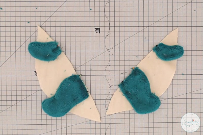 Handmade fabric pieces with teal fur for sewing and craft projects.
