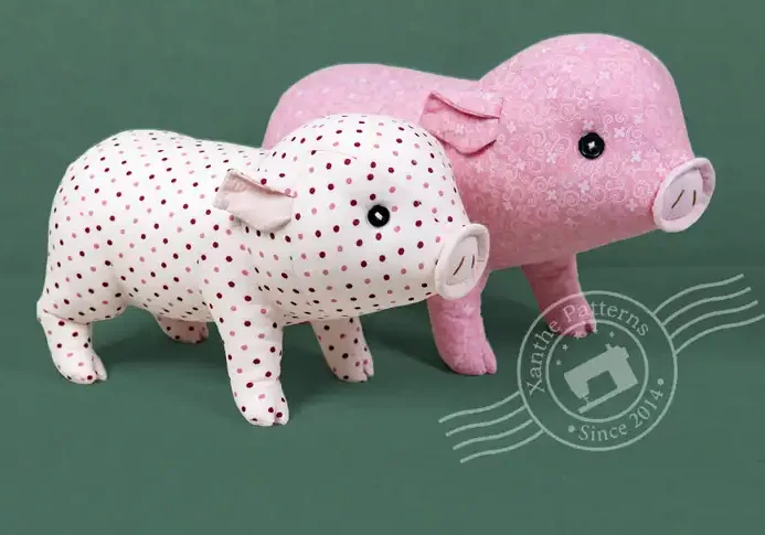 Cute pig plush toy sewing pattern with polka dots and pink fabric.