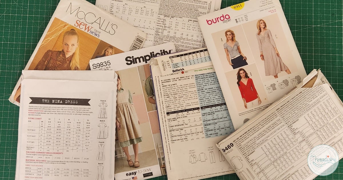 Collection of sewing pattern envelopes and instructions for sewing projects.